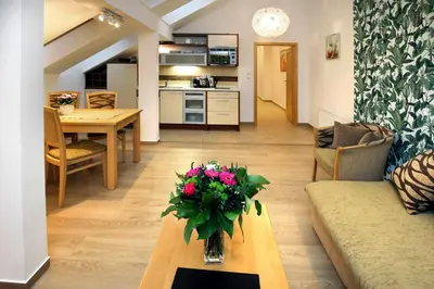 a living room with a vase of flowers on a table at Anděl Apartments Praha in Prague