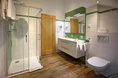 a bathroom with a shower and a sink and a toilet at Anděl Apartments Praha in Prague