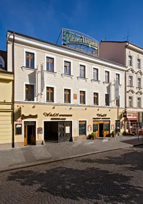 a large white building with a sign on top of it at Anděl Apartments Praha in Prague