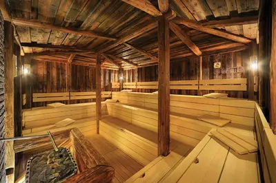 a large wooden sauna with wooden floors and ceilings at Absolutum Wellness Hotel in Prague