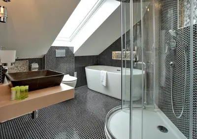 a bathroom with a shower and a tub and a sink at Absolutum Wellness Hotel in Prague