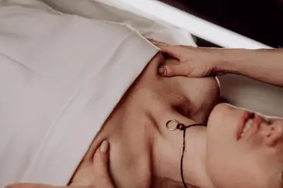 a man laying in bed with a pierced earring at Absolutum Wellness Hotel in Prague