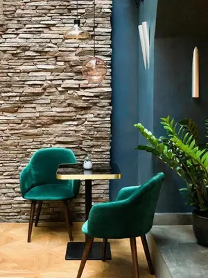 a room with two green chairs and a table at Design Hotel Neruda in Prague