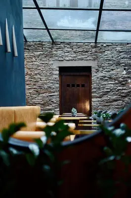 a room with a stone wall and a table and chairs at Design Hotel Neruda in Prague