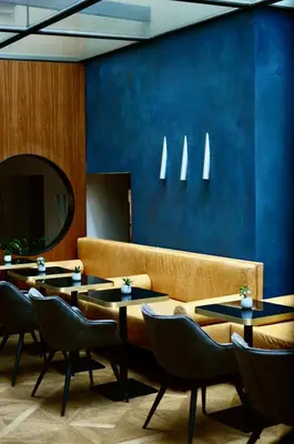 a restaurant with tables and a couch and a mirror at Design Hotel Neruda in Prague