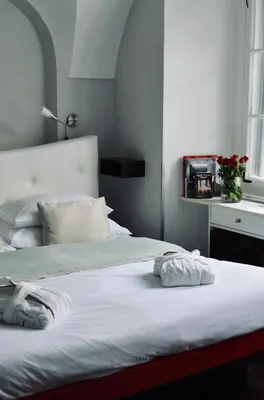 a bed with two towels on it in a bedroom at Design Hotel Neruda in Prague