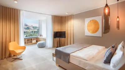 a bedroom with a large bed and a window at The President in Prague