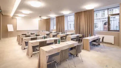 a conference room with tables and chairs and a whiteboard at The President in Prague