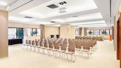 a conference room with chairs and a podium in the middle at The President in Prague