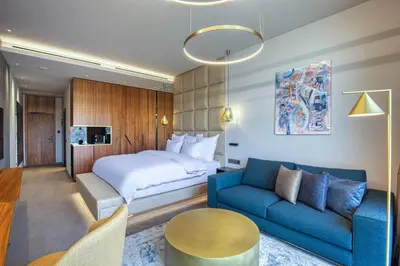 a hotel room with a bed and a blue couch at The President in Prague