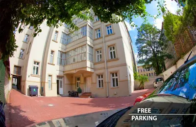 a building with a tree parking sign in front of it at Louis Leger - Czech Leading Hotels in Prague