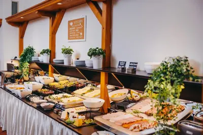 a buffet with a lot of food on a table at Louis Leger - Czech Leading Hotels in Prague