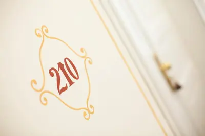 a sign on a wall with the number on it at Louis Leger - Czech Leading Hotels in Prague