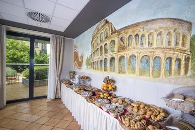 a wall with a painting of the coliseum at Hotel Roma Prague in Prague