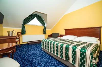 a hotel room with a bed and a table at Hotel Otakar in Prague