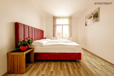 a bedroom with a large bed and a window at Hotel Otakar in Prague