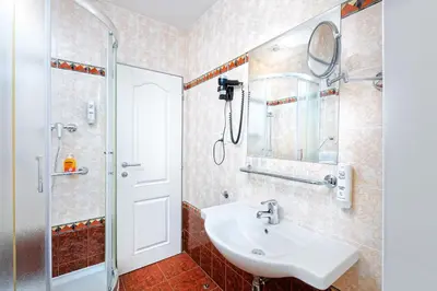 a bathroom with a sink and a shower at Hotel Aura Design & Garden Pool in Prague