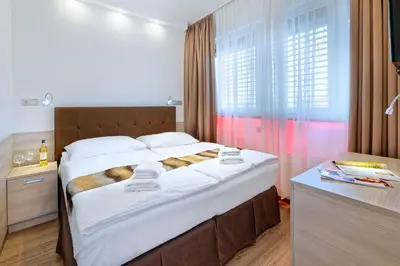 a bedroom with a large bed in a room at Hotel Aura Design & Garden Pool in Prague