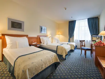a hotel room with a bed and a desk with a computer at Ramada Prague City Centre in Prague