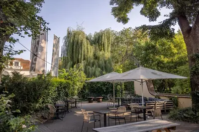 a bar with a tree in the middle of a room at Pytloun Old Armoury Hotel Prague, Stará Zbrojnice in Prague