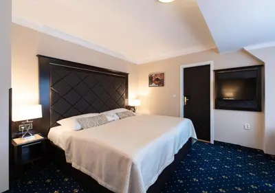 a hotel room with two beds and a couch at Pytloun Old Armoury Hotel Prague, Stará Zbrojnice in Prague
