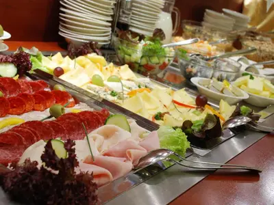 a buffet of different types of food on a table at Ramada Airport Hotel Prague in Prague