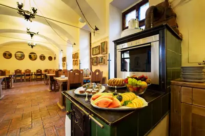 a plate of fruit on a counter in a restaurant at Hotel Selsky Dvur - Bohemian Village Courtyard in Prague