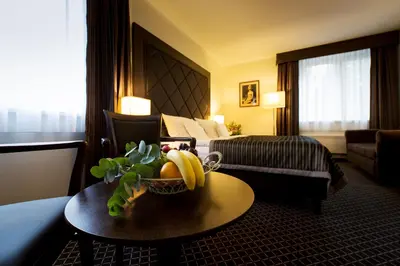 a hotel room with a bowl of fruit on a table at Hotel Selsky Dvur - Bohemian Village Courtyard in Prague