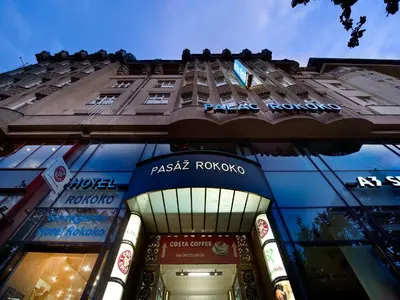 a tall building with a sign on the side of it at EA Hotel Rokoko in Prague