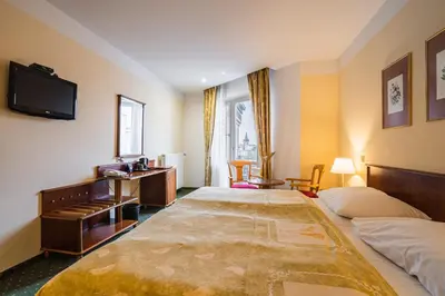 a hotel room with two beds and a television at EA Hotel Rokoko in Prague