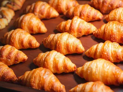 a bunch of croissants sitting on top of a tray at EA Hotel Rokoko in Prague
