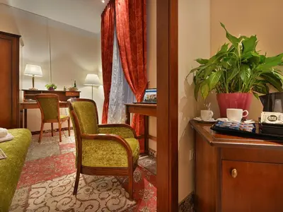 a living room with a chair and a desk at EA Hotel Jeleni Dvur Prague Castle in Prague