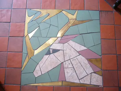 a mosaic of a bird on a tile floor at EA Hotel Jeleni Dvur Prague Castle in Prague