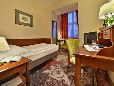 a hotel room with a bed and a desk at EA Hotel Jeleni Dvur Prague Castle in Prague