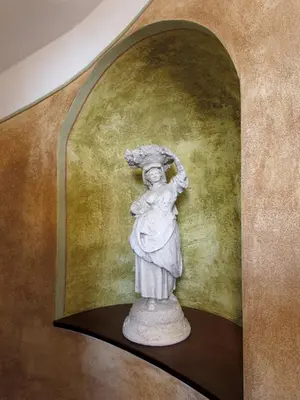 a statue of a woman standing on a shelf at EA Hotel Jeleni Dvur Prague Castle in Prague