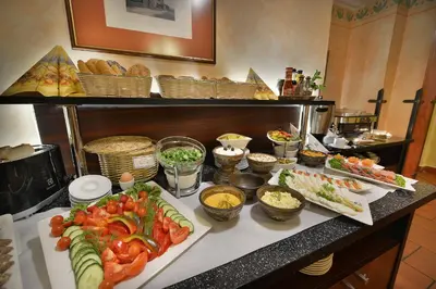 a buffet with many different types of food on a counter at EA Hotel Jeleni Dvur Prague Castle in Prague