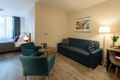 a hotel room with a bed and a living room at Hotel Melantrich Old Town in Prague