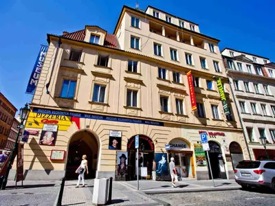 a street light with street signs in front of a building at Hotel Melantrich Old Town in Prague