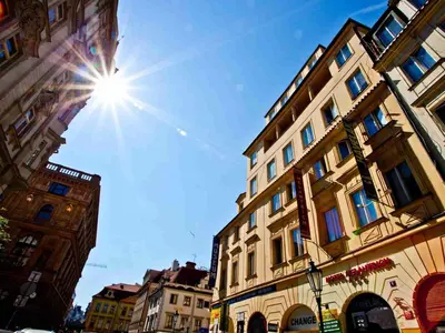 a large building with a hotel sign in front of it at Hotel Melantrich Old Town in Prague