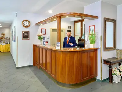 a hotel room with two beds and a door at Hotel Melantrich Old Town in Prague