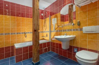 a bathroom with a toilet and a sink at Hotel William in Prague