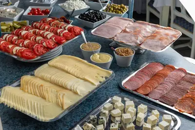 a table topped with lots of different types of food at Hotel William in Prague