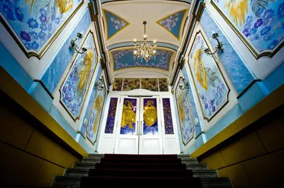 a staircase in a building with a chandelier at Hotel William in Prague