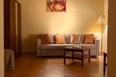 a living room with a couch and a table at Hotel William in Prague