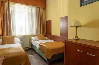 a hotel room with two beds and a window at Hotel William in Prague