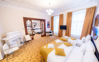 a bedroom with a large bed and a fireplace at Grandium Hotel Prague in Prague