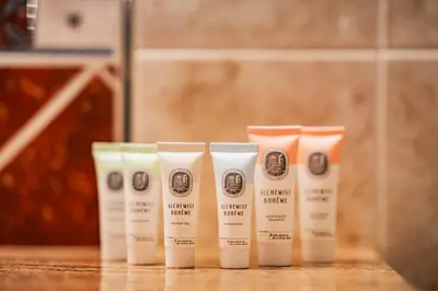 a row of four white products sitting on a counter at Hotel U Divadla - Czech Leading Hotels in Prague