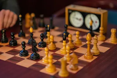 a chess board with chess pieces on it with a clock at Hotel U Divadla - Czech Leading Hotels in Prague