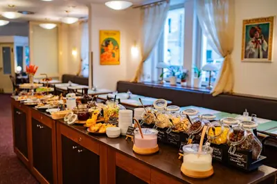 a buffet line with food and drinks on it at Hotel U Divadla - Czech Leading Hotels in Prague