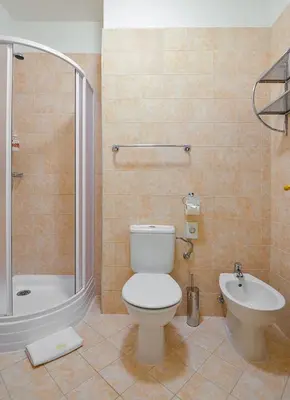 a bathroom with a toilet and a shower and a sink at Boutique Hotel Green Lobster in Prague